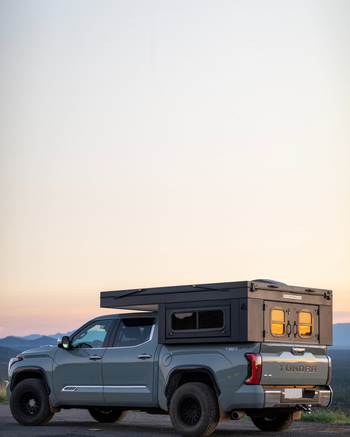 The Bruin XL extended-width hardwall camper on a pickup in canyon country