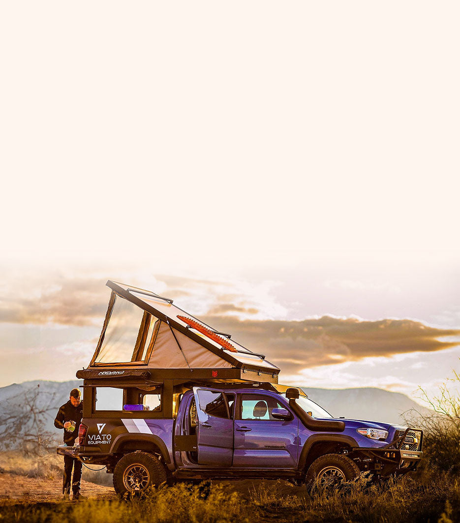 The Tenfold wedge-style pop-up camper on a pickup at a backcountry campsite