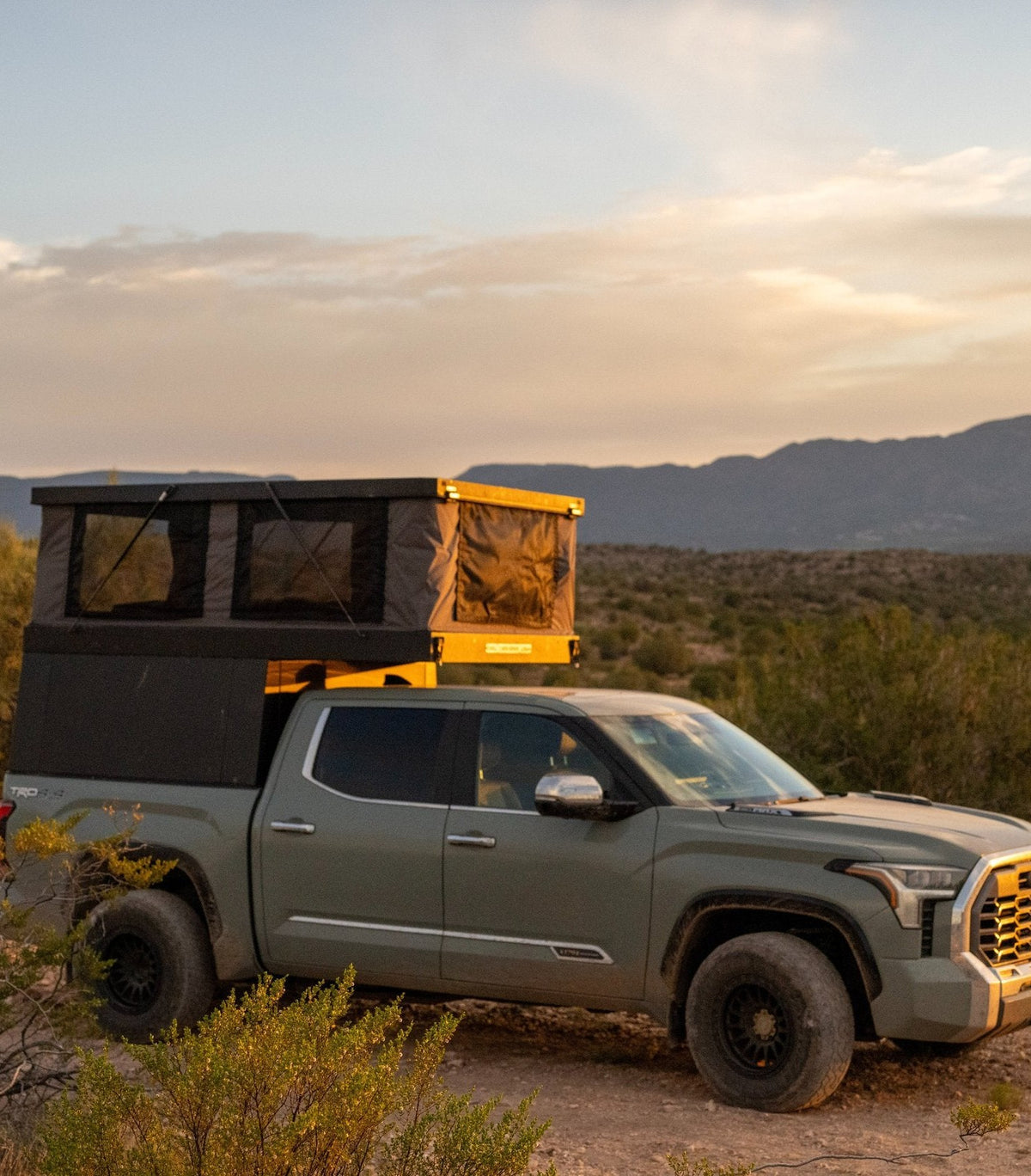 The Triton pop-up truck camper on a Toyota Tundra in the desert at sunset