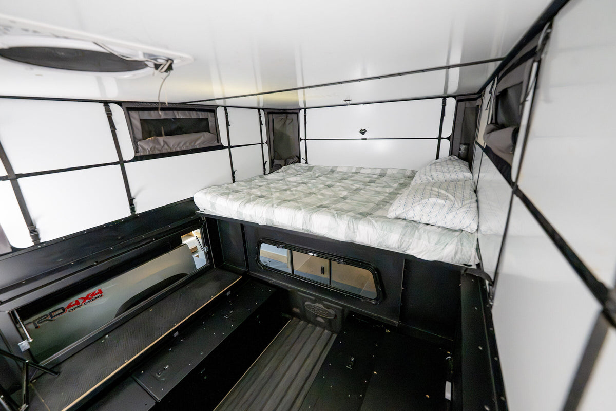Oru Bruin XL with the bed platform stowed above the cabover and the truck bed floor open below